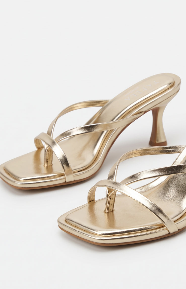Metallic gold kitten heels with thin multi-straps, a square toe, toe-post detail, and flared kitten heel