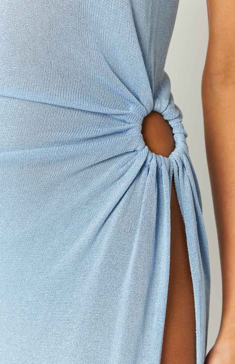 Close-up of the side O-ring cutout on a light blue knit dress, with ruched fabric creating a high split
