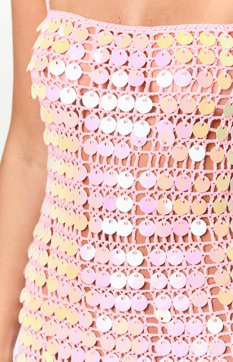 Close-up of the pink crochet knit fabric with round iridescent sequins
