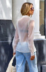 Rear view of a cream sheer button-through shirt with long sleeves and buttoned cuffs