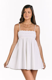 White babydoll mini dress with delicate eyelet embroidery along the square neckline and thin spaghetti straps