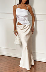 White asymmetric halter top with draped side detail and a contrasting champagne satin maxi dress