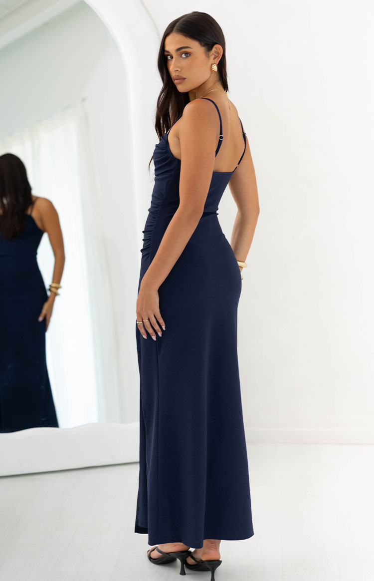 Side view of a navy crepe maxi dress showing the ruched bodice and adjustable spaghetti straps