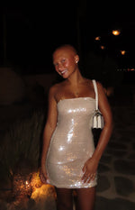 Front view of a gold sequin strapless bodycon mini dress with a shimmering finish