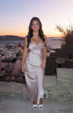 Mocha satin maxi dress featuring a cowl neck, thin spaghetti straps, and side cutouts