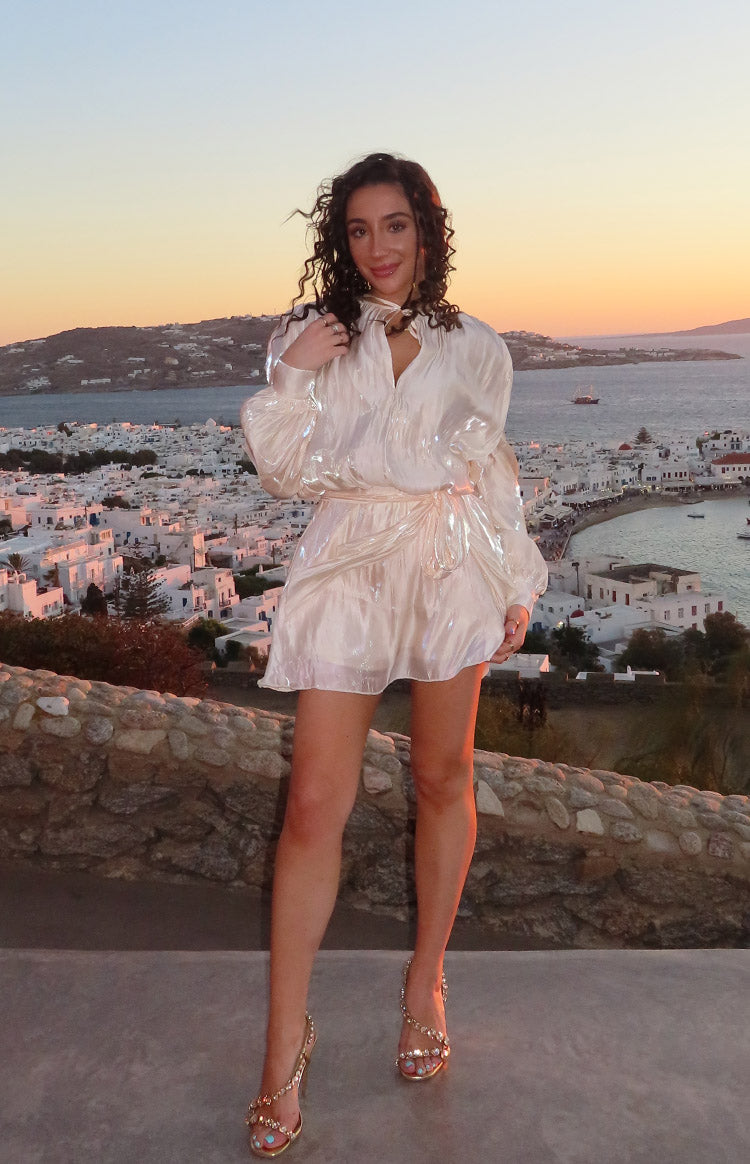 Pearl iridescent satin mini dress with long puff sleeves, V-neck tie collar, and a tie waist