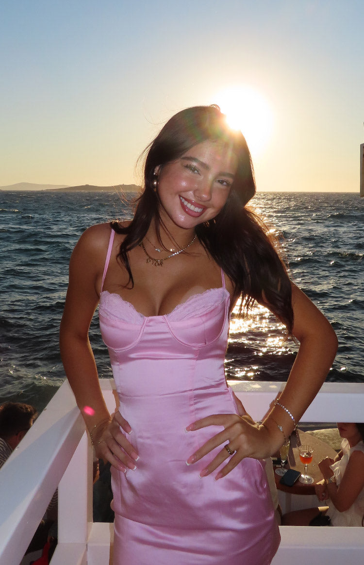 Front view of a light pink satin bodycon mini dress with a lace-trimmed sweetheart neckline and thin spaghetti straps