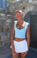Brown scoop neck tank top with thin spaghetti straps and a fitted cropped silhouette