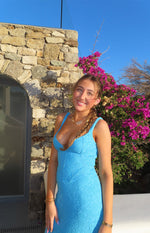 Blue lace maxi dress with a deep V-neckline and thin spaghetti straps, showing the fitted bodice
