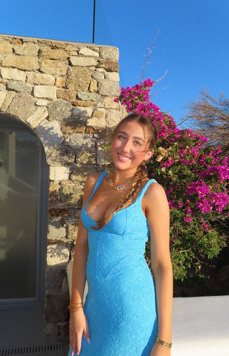 Blue lace maxi dress with a deep V-neckline and thin spaghetti straps, showing the fitted bodice