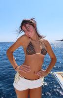 Brown polka dot triangle bikini top with yellow trim and adjustable tie straps