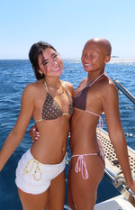 Side view of brown bikini bottoms with high-cut leg and adjustable pink tie sides
