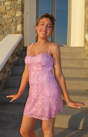 Front view of a pink sequin mini dress featuring a sweetheart neckline and wave-like sequin pattern