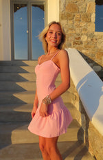 Pink crepe mini dress with a ruched sweetheart neckline, thin spaghetti straps, and a ruffled hem