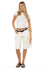 Front view of relaxed fit white denim shorts with visible front pockets and knee-length hem