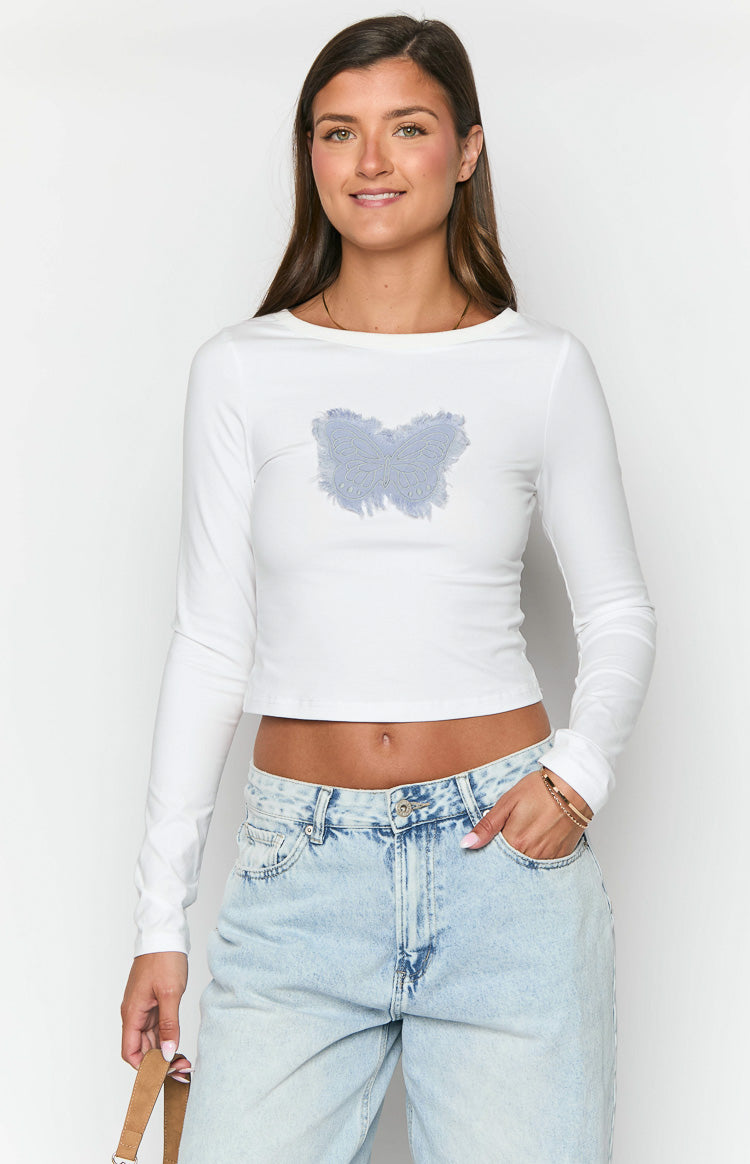 Front view of a white long sleeve crop top with a light blue butterfly graphic and frayed edges