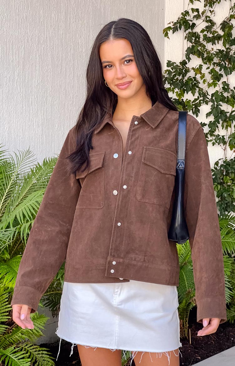 Front view of a chocolate brown suedette jacket with silver snap buttons and four front pockets