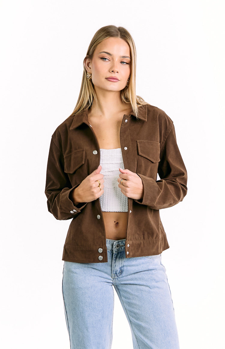 Front view of a chocolate brown suedette jacket with silver snap buttons, collared neckline, and flap chest pockets
