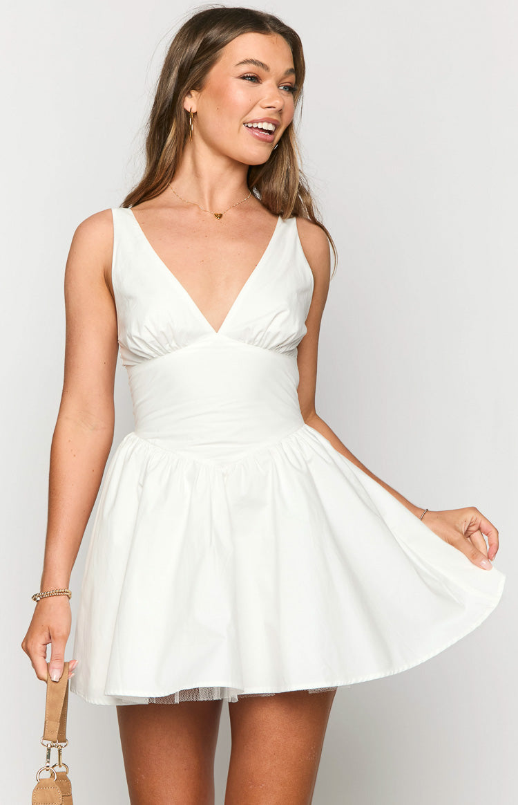 Front view of a white mini dress with a V-neck, gathered bust, fitted waist, and voluminous skirt with tulle underlay
