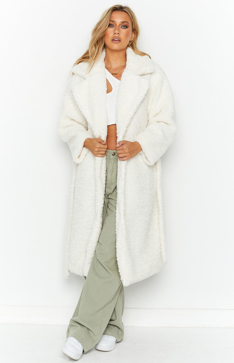 Front view of an open white teddy coat with wide lapels and a relaxed, longline fit