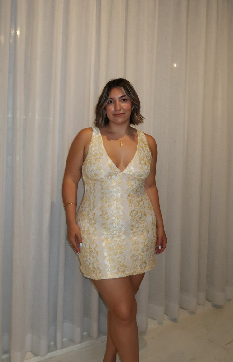 Front view of a yellow lace mini dress with a deep V-neck and fitted silhouette