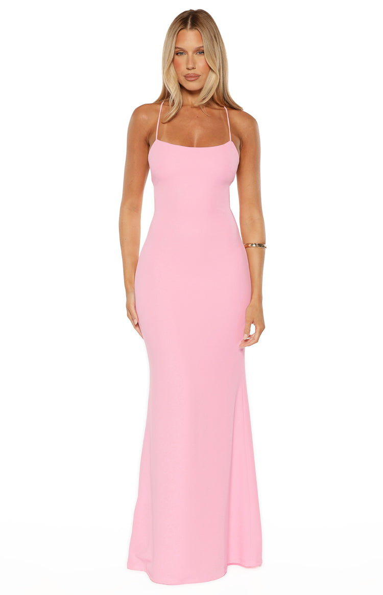 Front view of a pink crepe maxi dress with a straight neckline, thin spaghetti straps, and a fitted silhouette that gently flares at the hem