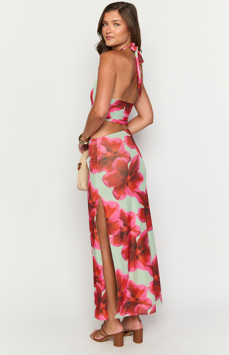 Side view of the green floral print maxi dress with a halter neck tie and a high side slit