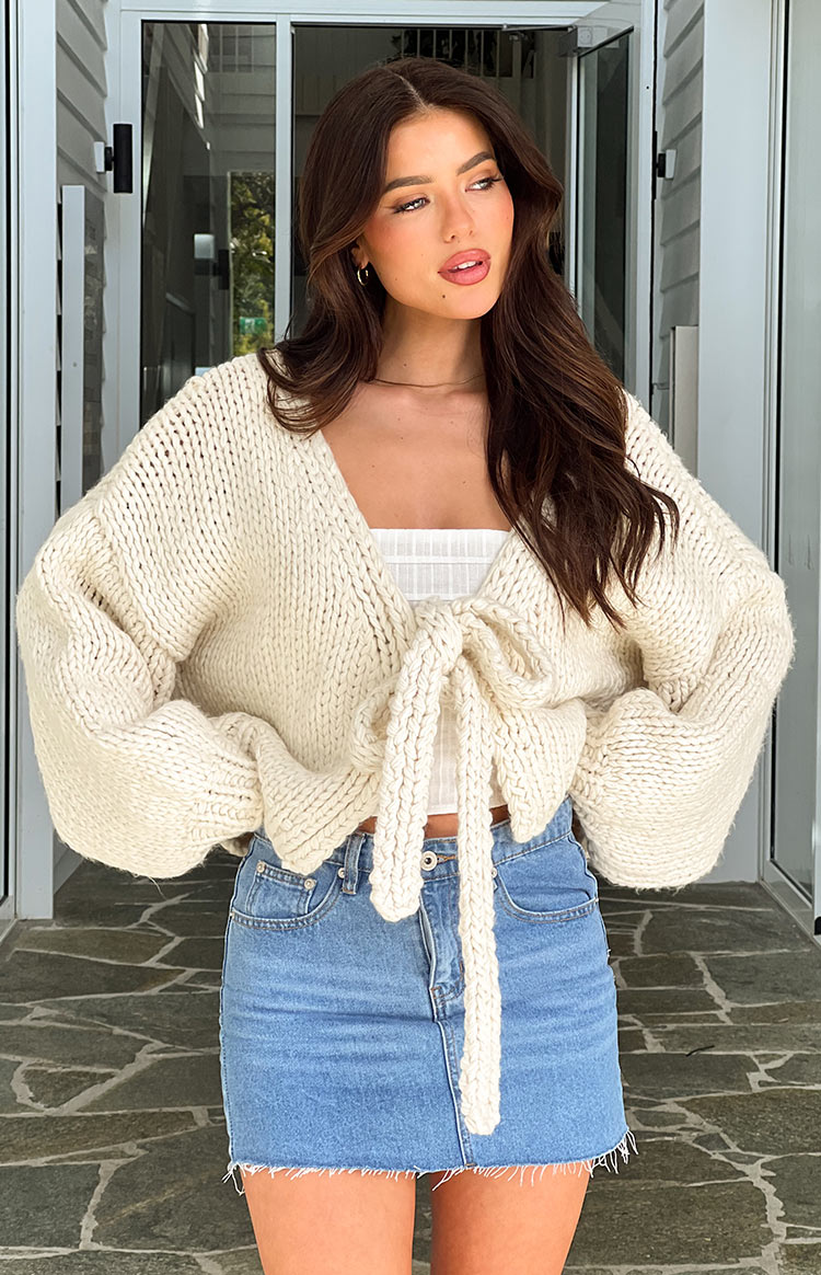 Cream chunky knit tie-up cardigan with voluminous balloon sleeves and a cropped fit