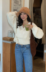 Front view of the cream chunky knit wrap cardigan with a deep V-neck and a tie closure at the waist