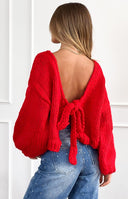 Front view of a red chunky knit cardigan with a wide boat neckline and relaxed long sleeves