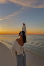 Beginning Boutique Holiday Cream Tie Up Knit Cardigan cream chunky knit V-neck cardigan with tie-up back and oversized sleeve