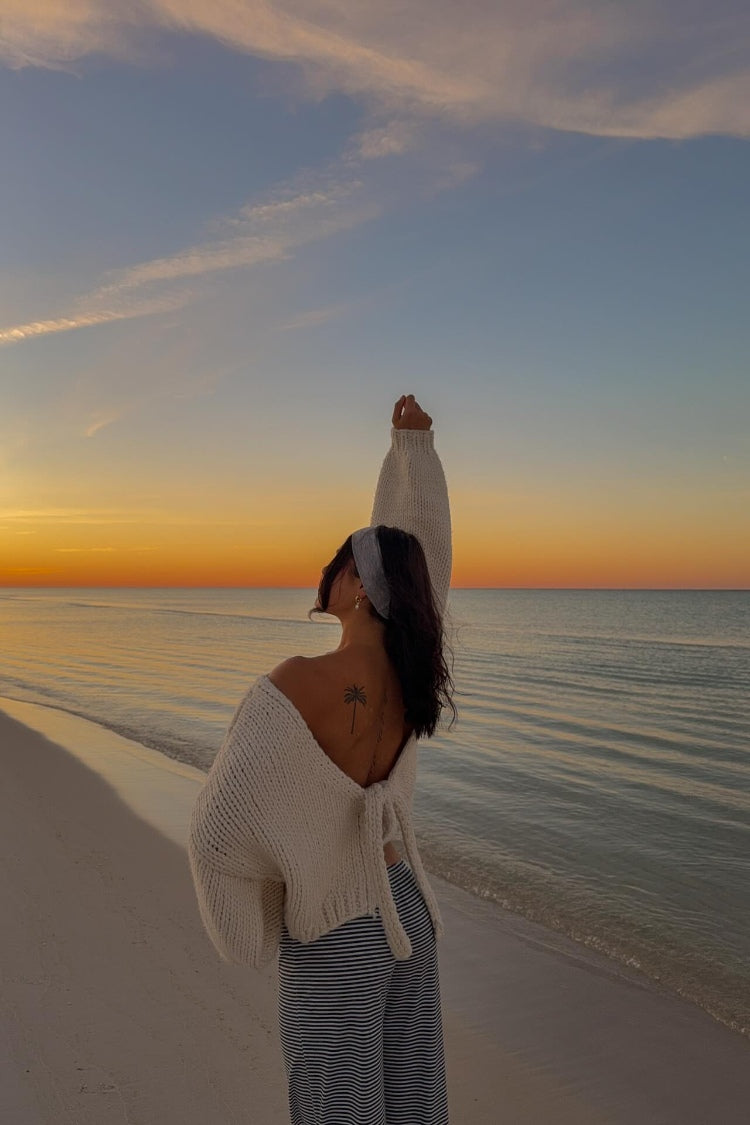 Beginning Boutique Holiday Cream Tie Up Knit Cardigan cream chunky knit V-neck cardigan with tie-up back and oversized sleeve