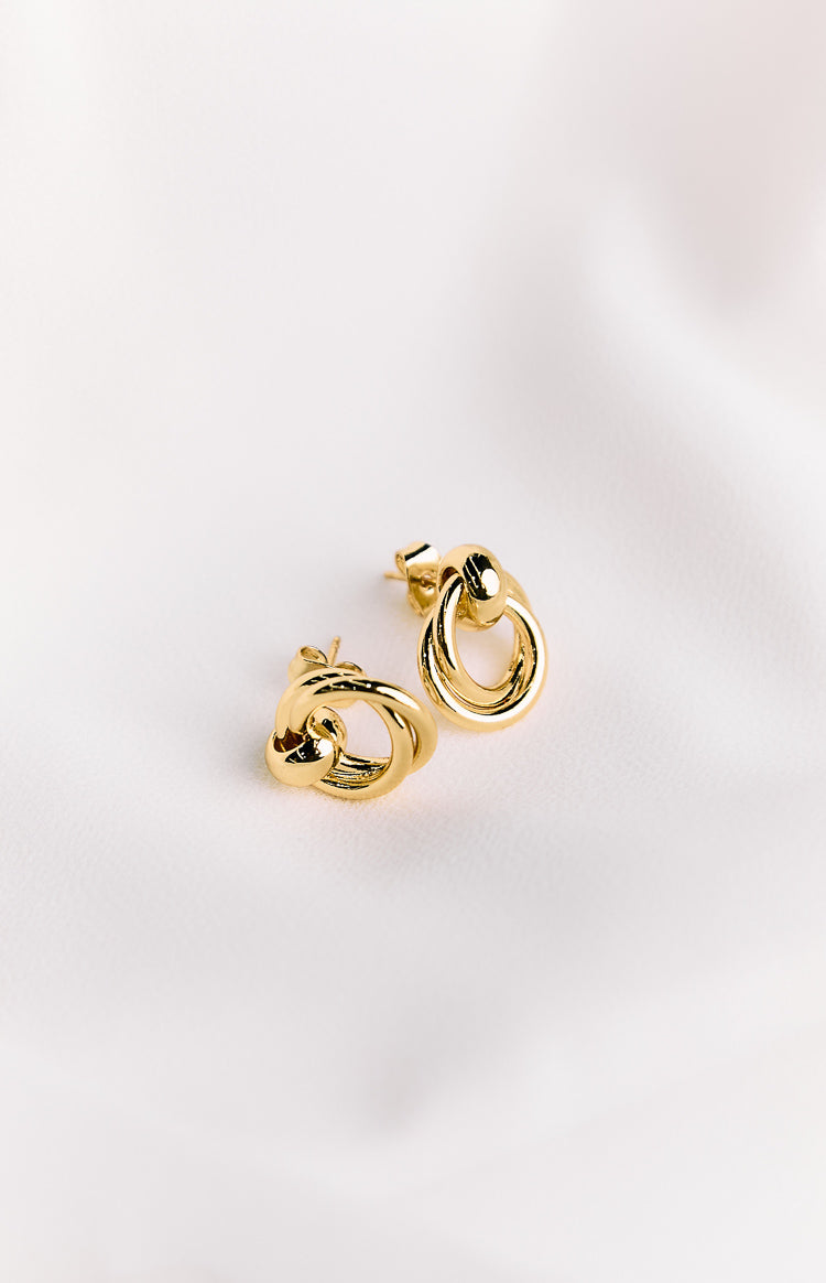 Pair of gold chunky hoop earrings with intertwined oval and twisted rings and visible stud backs