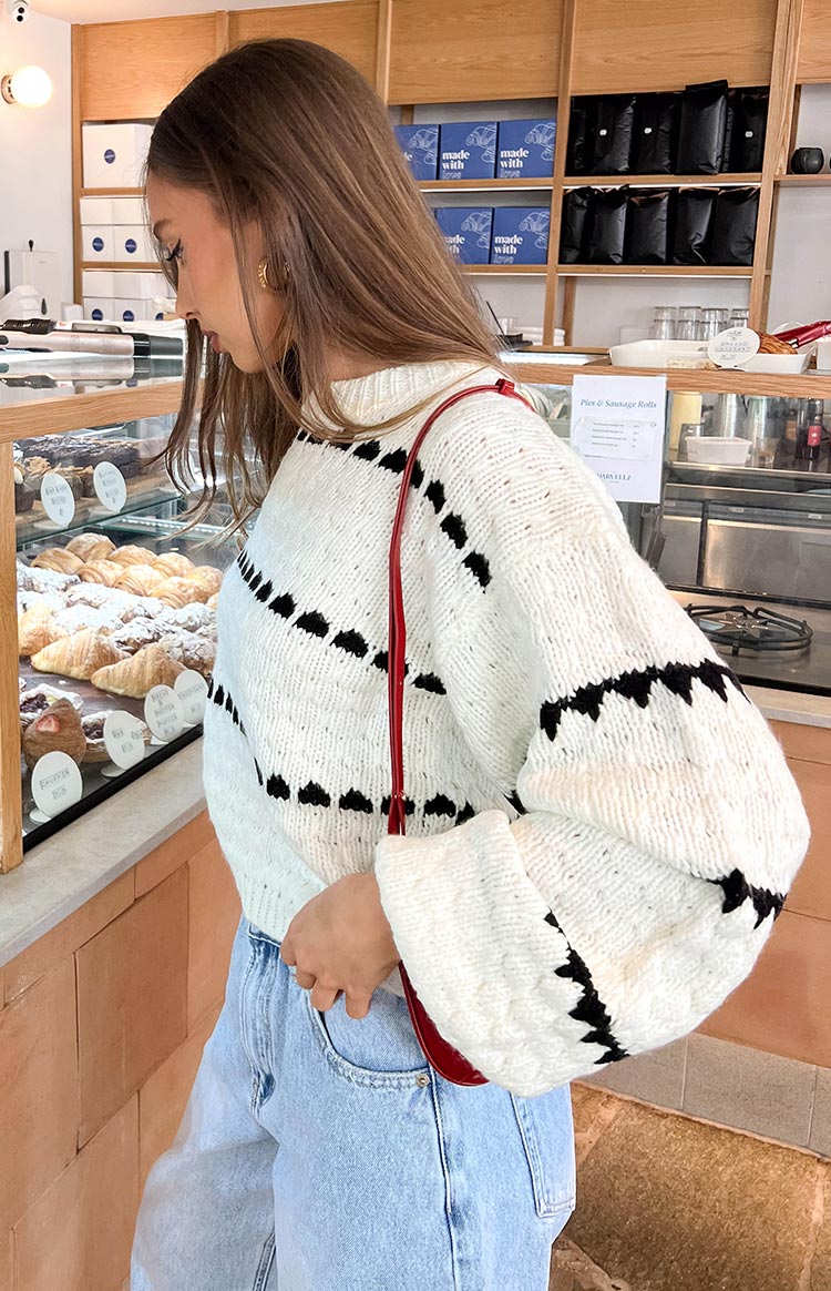 Beginning Boutique Holly White Heart Stripe Sweater white chunky knit crew neck sweater with black heart stripe pattern and oversized long sleeves