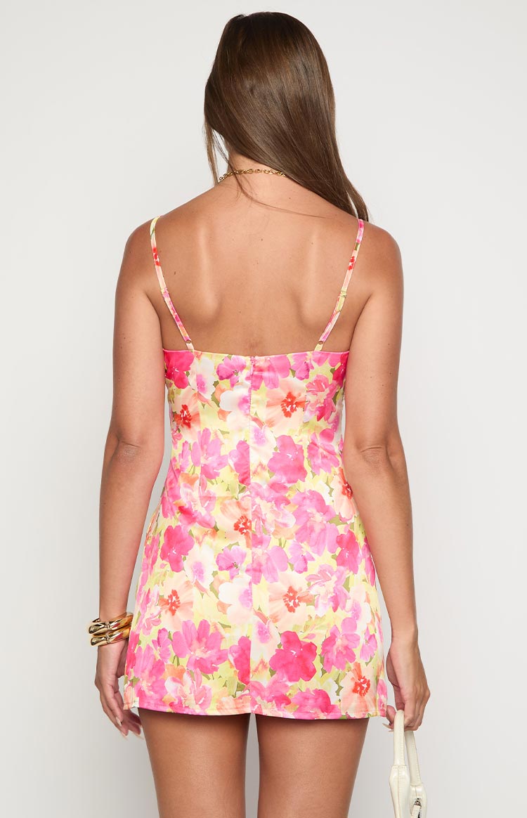 Rear view of a honey yellow floral mini dress with thin spaghetti straps and an invisible back zipper