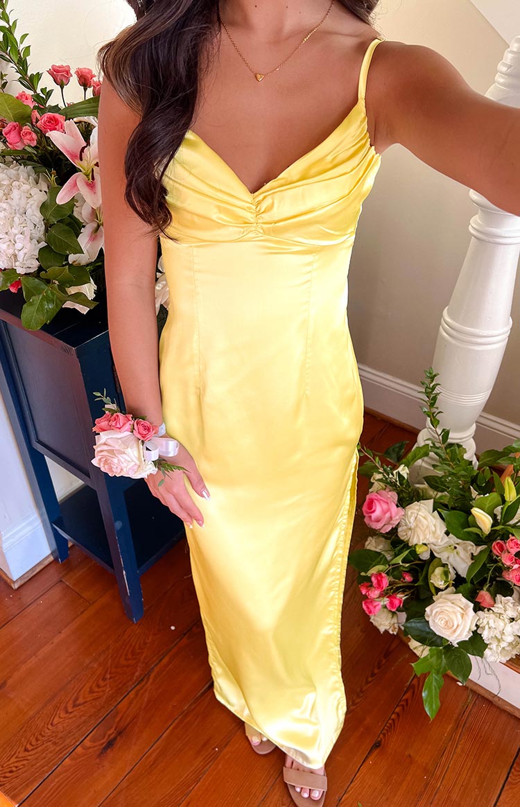 Full length view of a honey yellow satin maxi dress with a ruched sweetheart neckline, spaghetti straps, and a side slit
