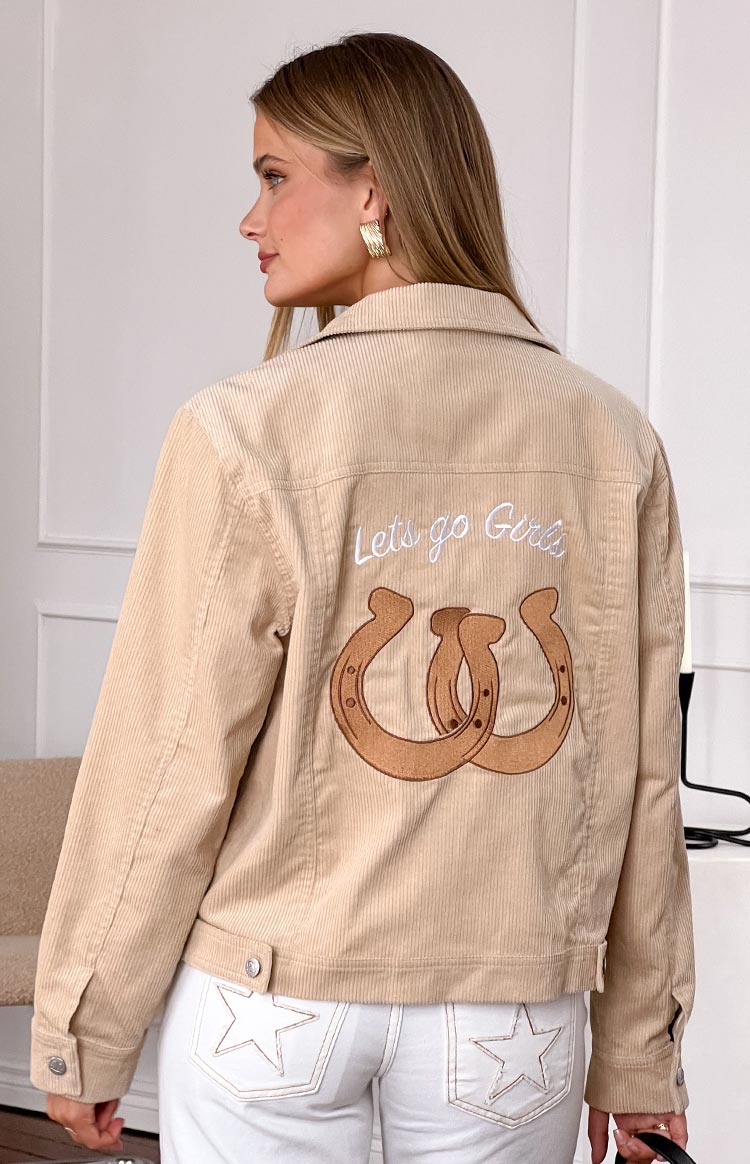 Rear view of a cream cord western jacket with "Lets go Girls" text and two horseshoe embroidery on the back