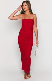 Red strapless bodycon maxi dress with extensive ruching down the bodice and skirt