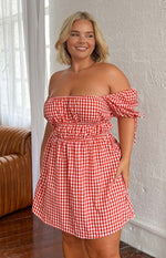 Red and white gingham mini dress with an off-shoulder neckline, shirred bust and waist, and short tie-detail puff sleeves