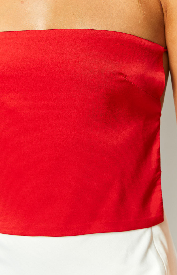 Close-up of the red satin strapless top showing the fabric texture and bust dart detail