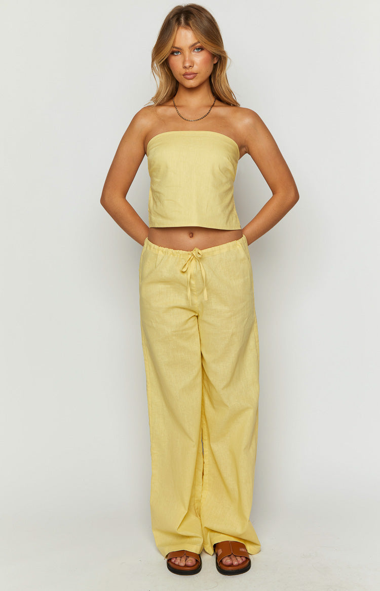 Full length view of a yellow strapless crop top with a straight neckline and textured fabric