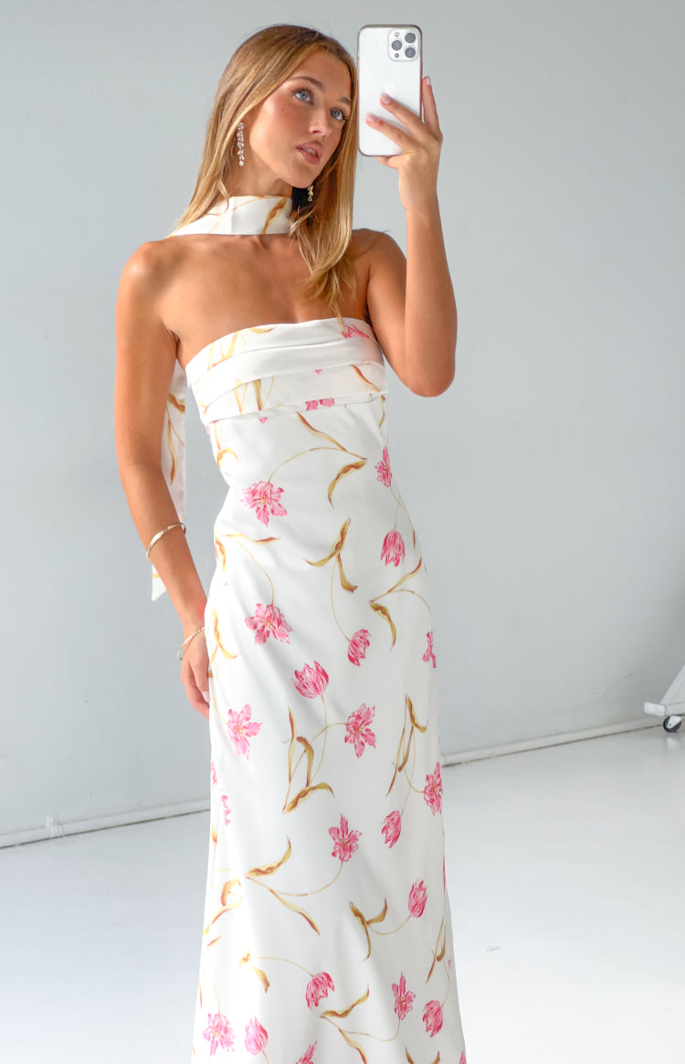 Side view of a cream floral print satin strapless maxi dress with a matching scarf detail