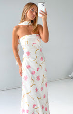 Side view of a cream floral print satin strapless maxi dress with a matching scarf detail