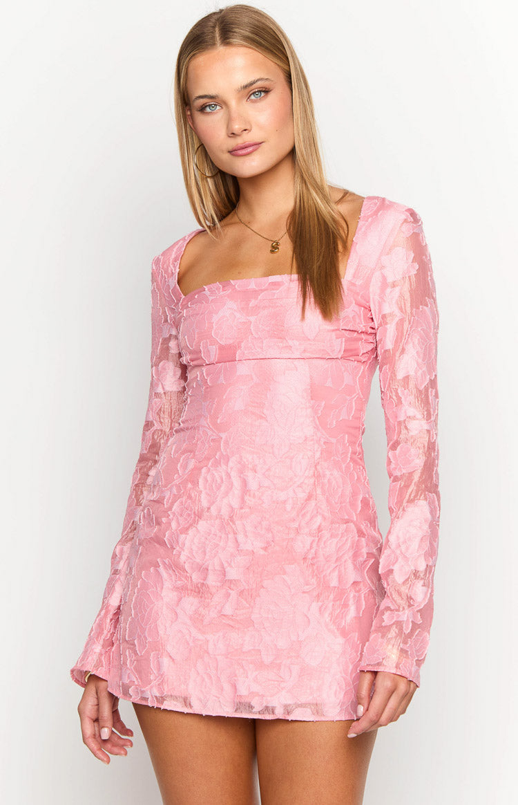 Close-up of the square neckline and textured pink floral fabric of a long sleeve mini dress