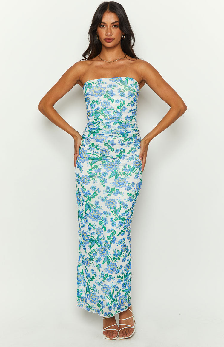 Full length front view of a white strapless maxi dress with blue and green floral print and ruched sides