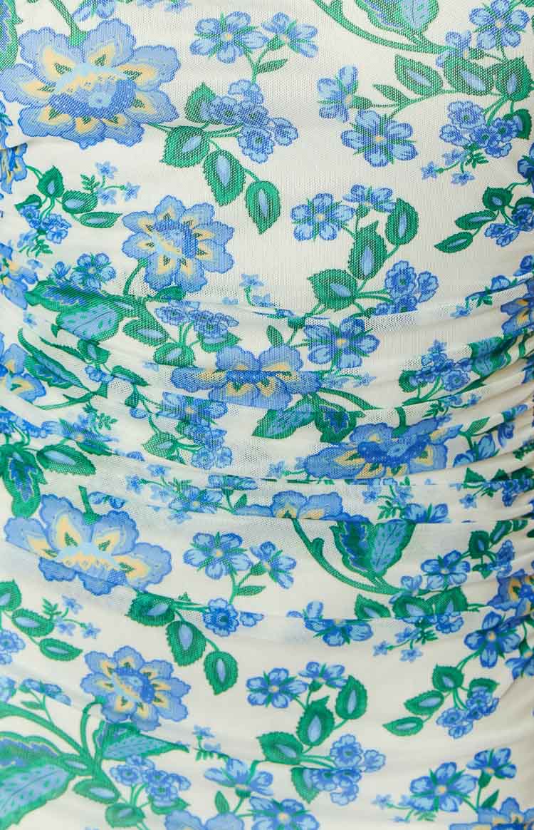 Close-up of the white mesh fabric with blue and green floral print and ruched detailing