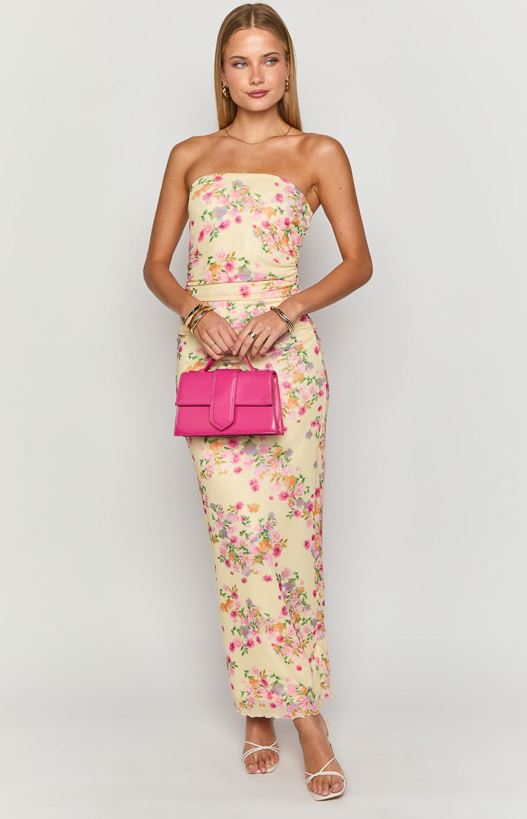Full length front view of a yellow floral strapless maxi dress with a bodycon fit