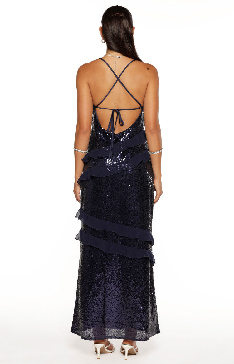 Full back view of a navy sequin maxi dress with a low scoop back, criss-cross spaghetti straps, and tiered chiffon ruffles