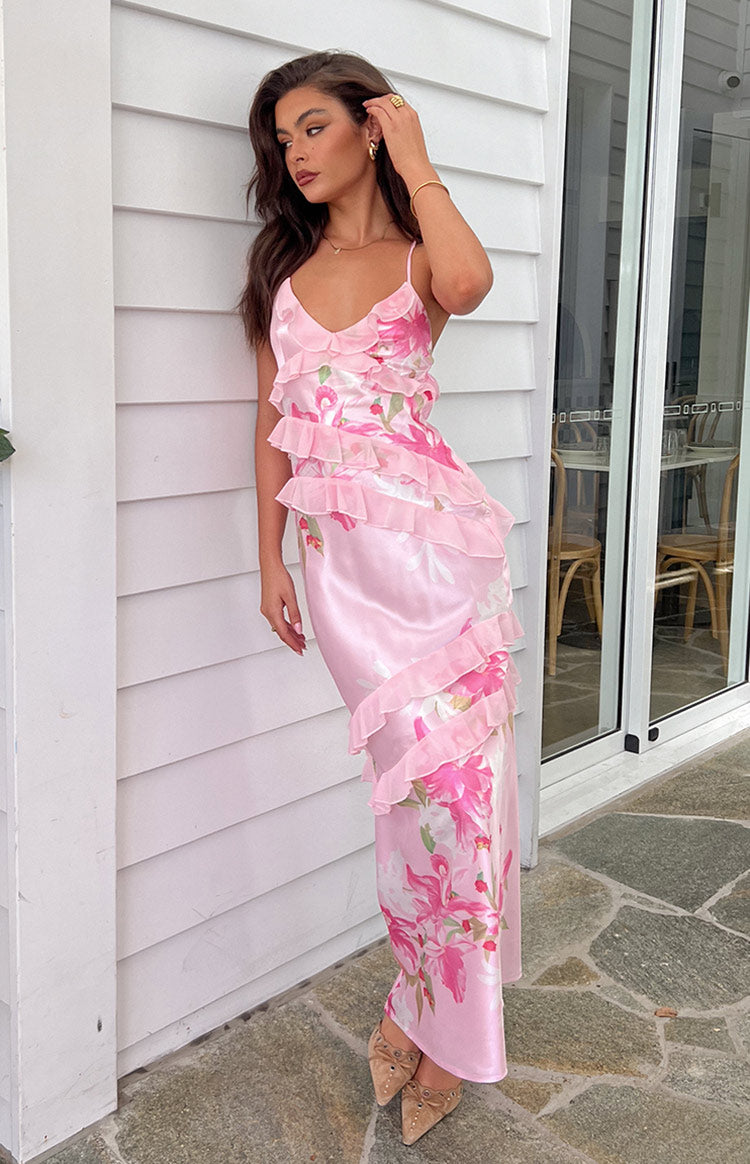 Side view of a pink floral print maxi dress with cascading ruffles down the side