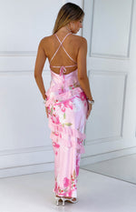Rear view of a pink floral print maxi dress with criss-cross tie-back straps, low scoop back, and tiered ruffles